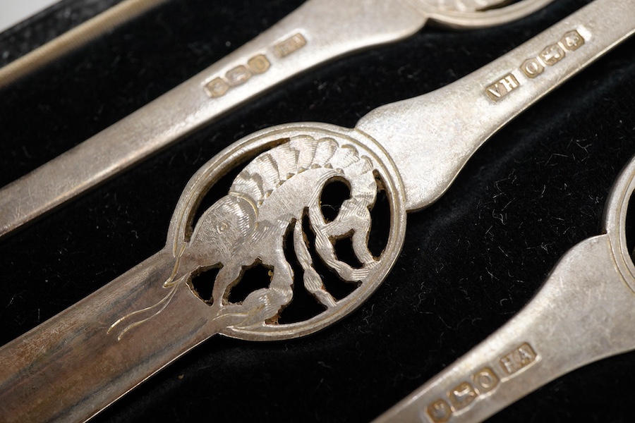 Four assorted cased silver sets including two handled christening bowl and spoon, Birmingham, 1934, a similar christening mug, set of six teaspoons with sugar tongs and six George V lobster picks.